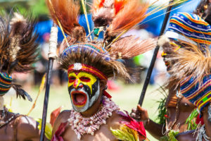 Portrait: Western Highland Man in face paint and feathered hat, Mt Hagen Cultural Show, PNG