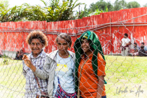 Papuan women outside a mesh fence, Mt Hagen Cultural Show, PNG