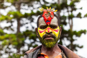 Portrait: Western Highland Man in face paint and bird headdress, Mt Hagen Cultural Show, PNG