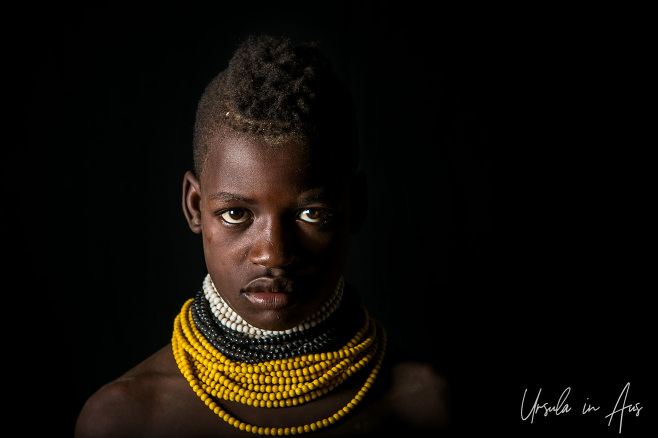 Portrait: Kara youngster against black, Dus Village Ethiopia