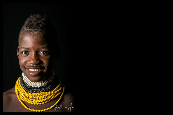 Portrait: Smiling Kara Youngster against black, Dus Village Ethiopia