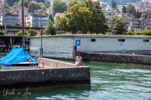 Woman on the waterfront, from the water, Switzerland.