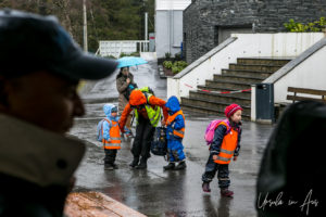 Kindergarten children and teacher in hi-viz vests, Mt Fløyen, Norway