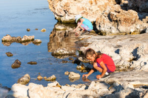 Children collecting water from the lake, Mono Lake Tufa State Natural Reserve, California USA