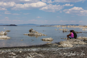 People seated on foreshore tufas, Mono Lake Tufa State Natural Reserve, California USA