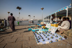 Small souvenirs on white cloths, Philae Temple boat dock, Egypt
