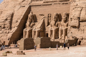 People at the feet of the seated Colossi outside the Great Temple, Abu Simbel Egypt