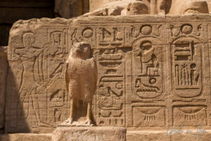 Sculpture of Horus in front of a tablet of hieroglyphs, the Great Temple, Abu Simbel Egypt.