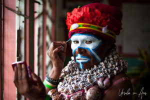 Portrait: Western Highlands Woman applying face paint, Mt Hagen PNG