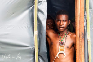 Papuan man in a plastic-coated doorway, Mt Hagen PNG.