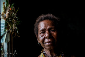 Portrait: Papuan woman with short hair and facial tattoos, Mt Hagen PNG