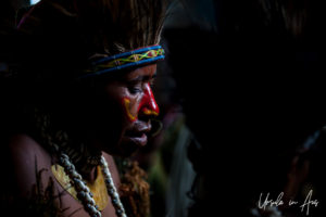 Portrait: Young Papuan man in profile, in face paint and headdress, Mt Hagen PNG