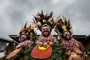 Three Western Highland women standing tall against an overcast sky, Mt Hagen, Papua New Guinea