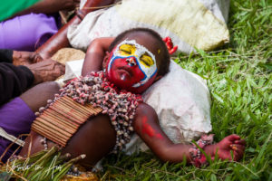 Sleeping Western Highlands child in face paint, Mt Hagen Festival, Papua New Guinea