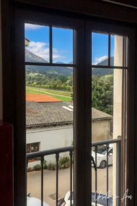Views over the hills around Panes through a wooden-frame window, Asturias Spain.