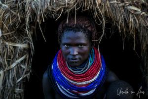 Portrait: Nyangatom Woman in a doorway, Omo Valley, Ethiopia