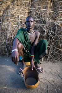 Portrait: Nyangatom man sitting, Omo Valley, Ethiopia