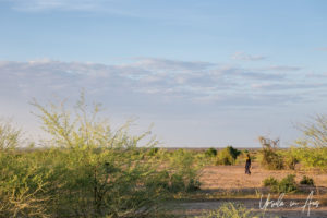 Woman walking, Nyangatom village, Omo Valley, Ethiopia