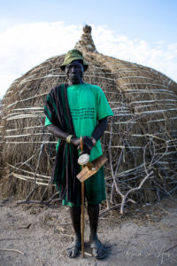 Portrait: Nyangatom man in a green t-shirt, Omo Valley, Ethiopia