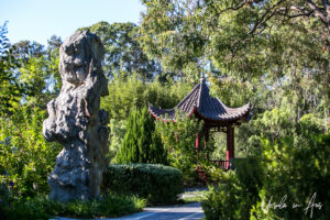 Chinese pavilion and a sculptured standing stone, Bundaberg Botanic Gardens, Queensland Australia.