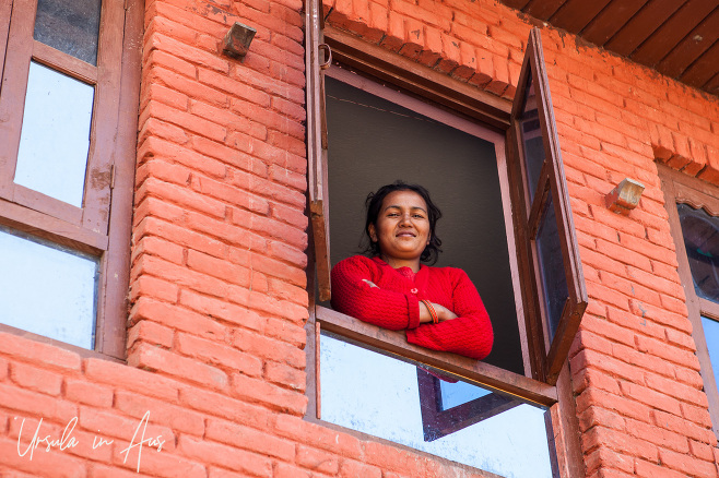 Woman looking down from a window, Changunarayan, Nepal