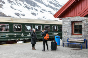 Couple taking pictures in front of the Flåm train, Myrdal, Flåmsbana, Norway