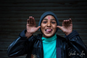 Portrait: Child with his tongue out, Haridwar India