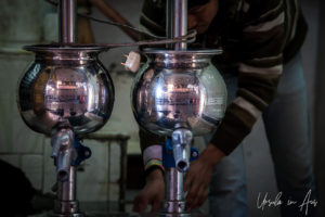 Man cleaning the lassi-making equipment, Haridwar, India