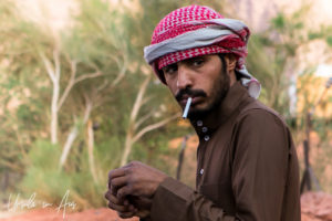 Portrait: Bedouin man in a Keffiyeh with a cigarette, Wadi Rum, Jordan