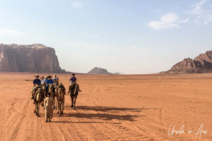 Tourists camel-riding in Wadi Rum, Jordan