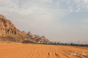 Tourists camel-riding towards Wadi Rum Village, Jordan