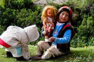 Peruvian child with a bedraggled doll, Tambomachay, Cusco, Peru