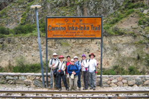 A group of trekkers at the signpost for the Inka Trail at Piscacucho, Peru