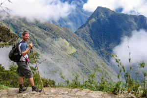 Hiker overlooking the Andes at Puyupatamarca, the Inca Trail, Peru