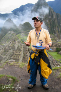 Peruvian male guide in front of Machu Picchu.