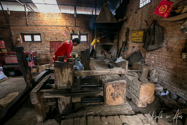 Workers on a traditional mustard oil factory floor, Khokana, Nepal