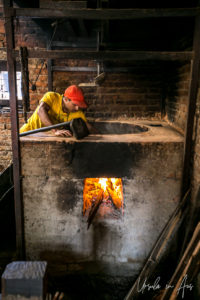 Man roasting mustard seed, Khokana factory, Nepal