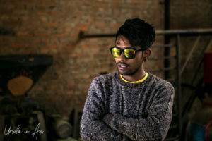 Portrait: Nepali man in sunglasses, Khokana mustard factory, Nepal