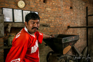 Portrait: Newari man in a Khokana mustard factory, Nepal