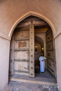 Omani man in a doorway, Al Hazm Castle, Oman