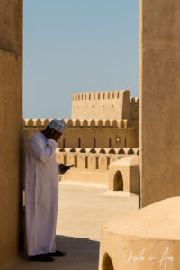 Omani man in a doorway, Al Hazm Castle, Oman