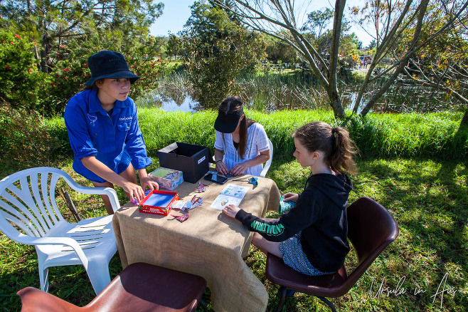 Children following an origami book, Panboola Wetlands, Pambula NSW Australia