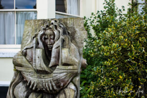 Wooden carving of a woman serving food, Caerleon, Wales