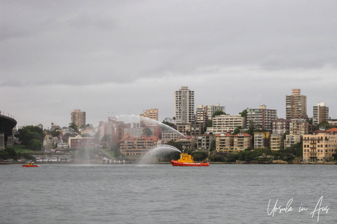 Sydney Port Corporation tugboat spouting water, Sydney Harbour, Australia.