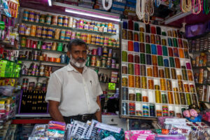 Salesman in a trinket shop, Chennai, Tamil Nadu India