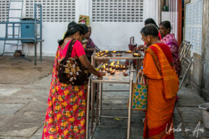 Women lighting clay gee lamps, Kapaleeshwarar Temple, Chennai, Tamil Nadu India