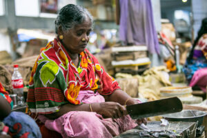Woman cutting fish, Goubert Market, Puducherry, India.