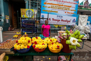 A table laden with flower offerings outside Vedapureeswarar Temple, Pondicherry India.