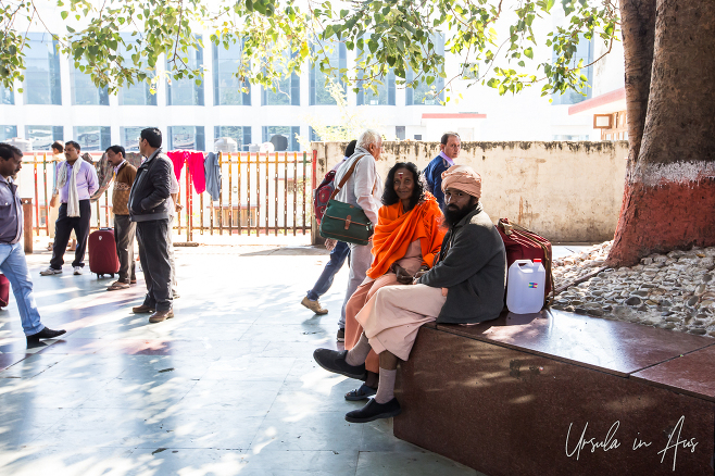 A couple seated on a stone bench, Haridwar Station, India
