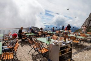 People at tables on the observation deck on Pilatus, Switzerland